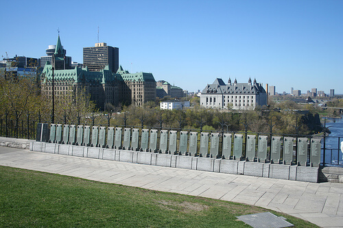 Memorial panels in Ottawa with the Canadian Parliament buildings in the background.