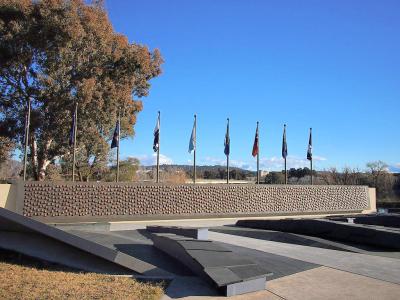 Stone wall memorial with flags, National Police Memorial of Australia in Canberra.
