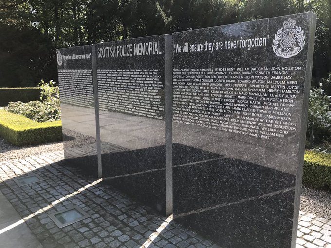 Three polished granite memorial panels in a garden, the Scottish Police Memorial.
