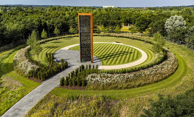 Tall corten steel monument in a circular landscaped setting, UK National Police Memorial.